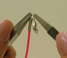 Pliers adding a jump ring to coil end